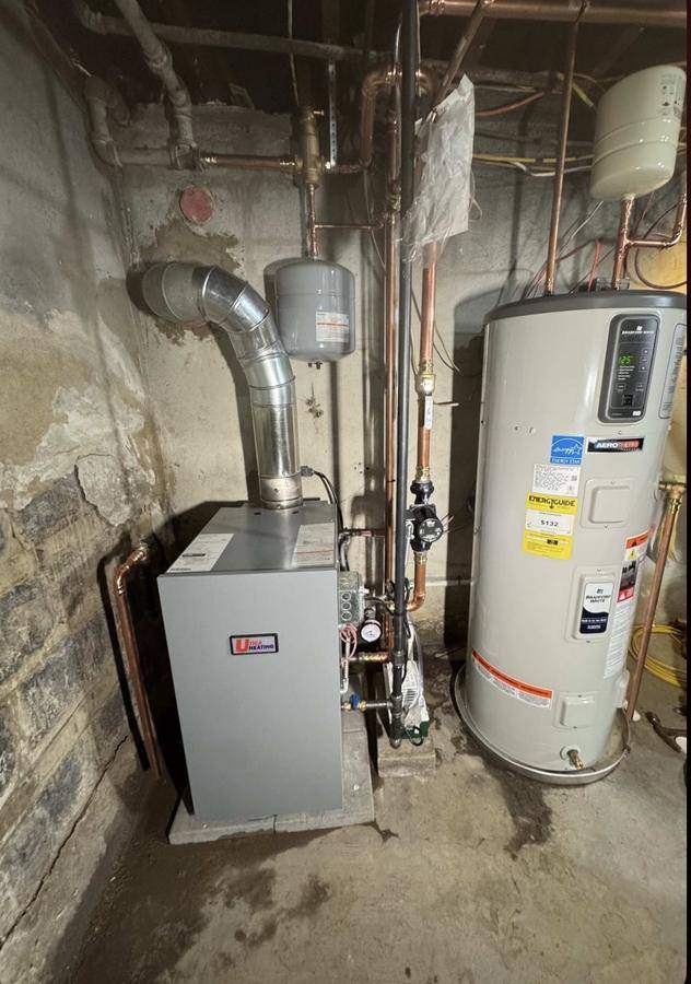 New Utica Heating boiler and Bradford White AeroTherm heat pump water heater installed side by side with new copper and venting